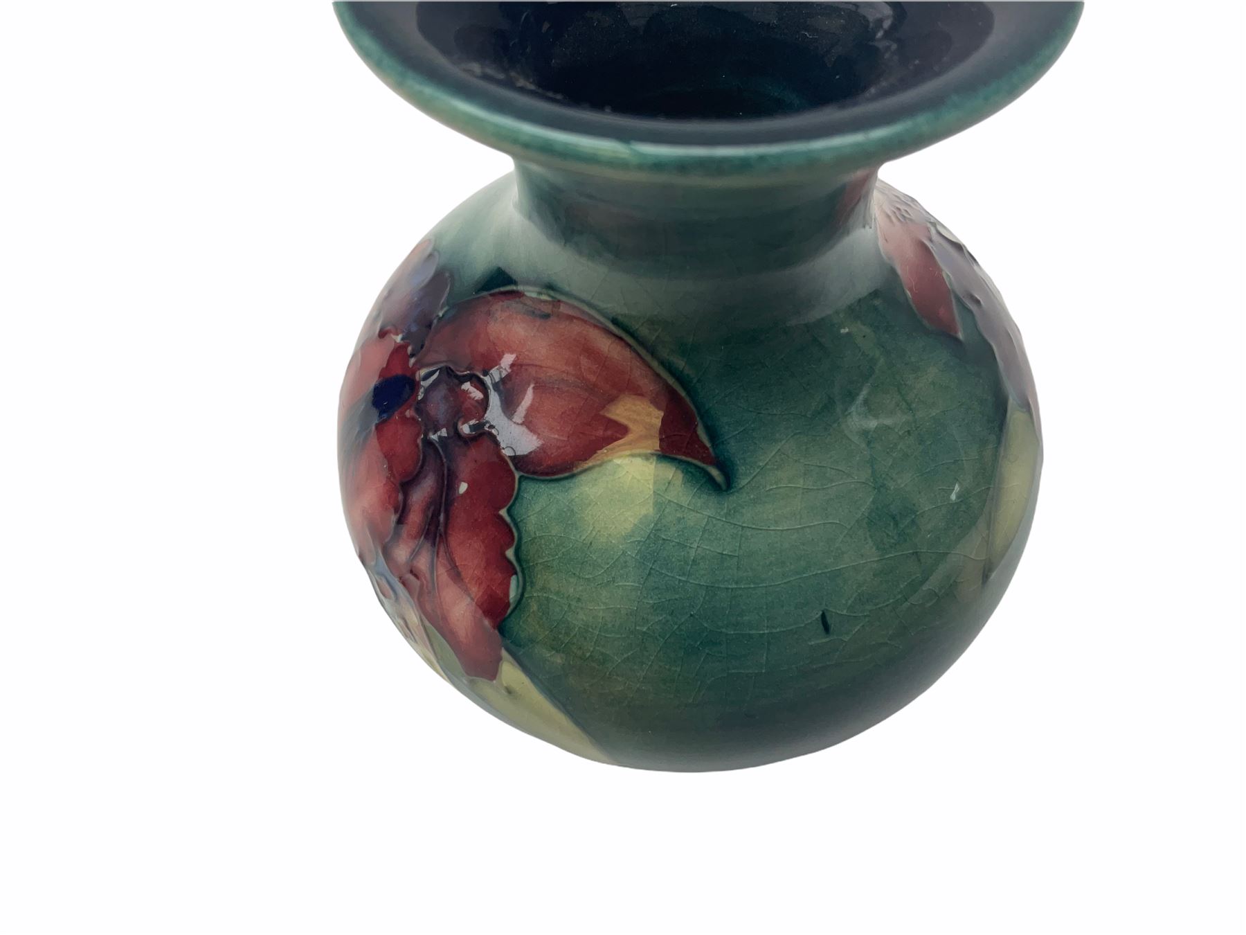 Moorcroft vase, decorated in the Leaf and Berries pattern upon a tonal green ground, together with a further Moorcroft vase, of squat baluster form, decorated in the Iris pattern upon a tonal green ground, each with impressed marks beneath, each H9cm. 