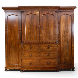 Early 19th century figured mahogany combination wardrobe, the breakfront architectural cor...