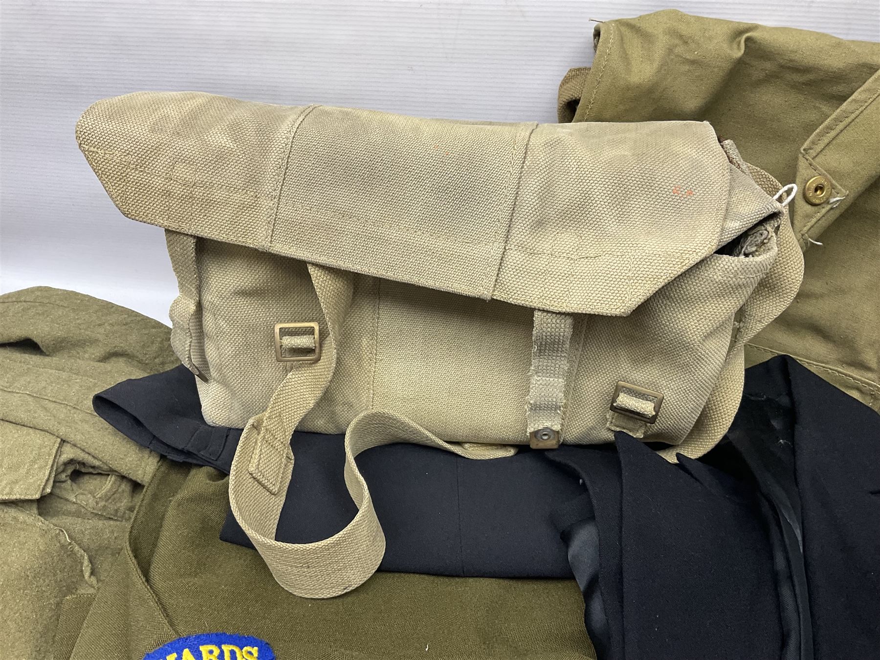 Two post-WWII British Army No.2 Dress tunics, one with Green Howards buttons; army shirt dated 1951; Royal Fleet Auxilliary jacket with trousers; three RAF/WAAF uniforms and RAF Greatcoat; and three canvas/webbing bags, two dated 1943 & 1945