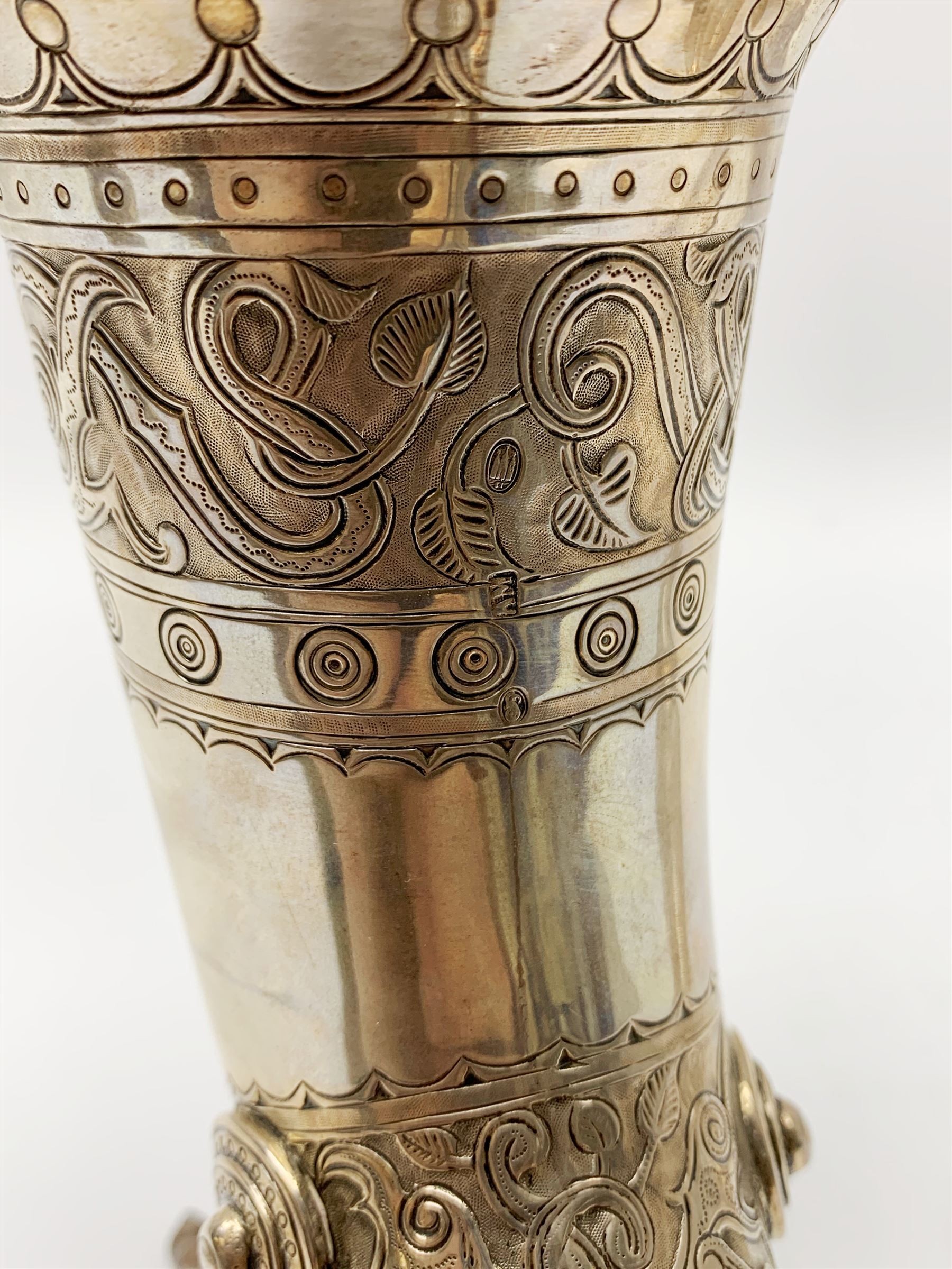 Late 19th century Danish silver drinking horn and cover, the body with hexagonal and beaded finial, raised upon two talon feet and further scroll foot, chased with scrolling foliate and zoomorphic bands, the detachable domed cover with conforming decoration surmounted by a figure holding a hammer, the cover interior impressed with maker's mark (partly worn and indistinct), alongside Danish Three Towers mark for 1881, with the Assay Master mark for Simon Groth (1863-1904), H23.5cm, weight 14.75 ozt (459 grams)


