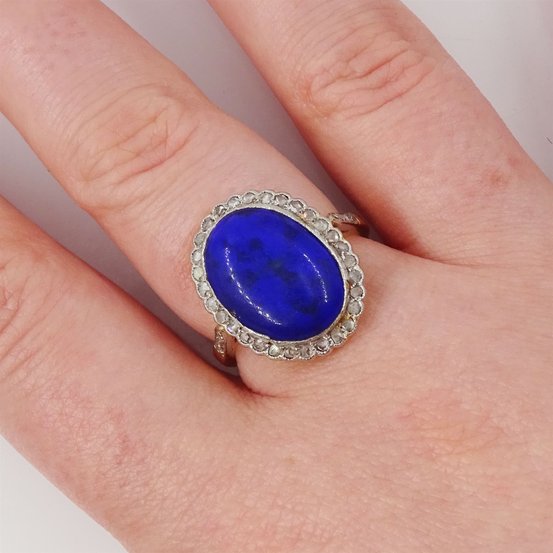 Early - mid 20th century 18ct gold and platinum lapis lazuli and diamond cluster ring, oval cut lapis lazuli surrounded by milgrain set rose cut diamonds, with diamond set shoulders