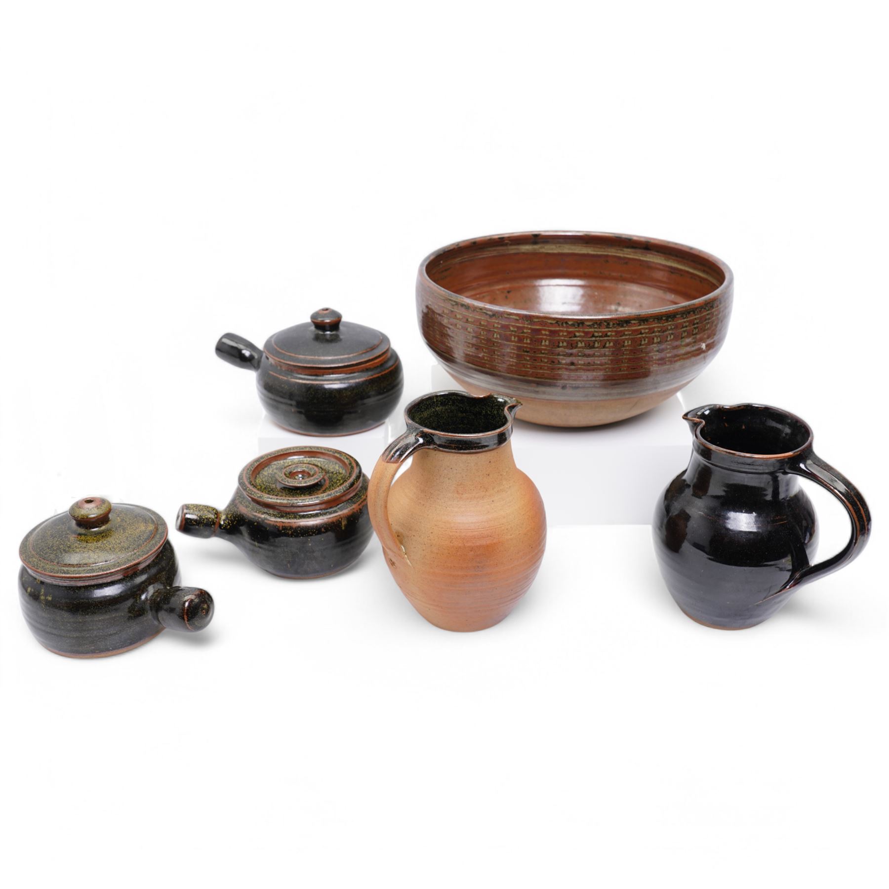 Collection of Winchcombe studio pottery, including various casserole dishes, two jugs and a large bowl, most with impressed marks, bowl D35cm (6)