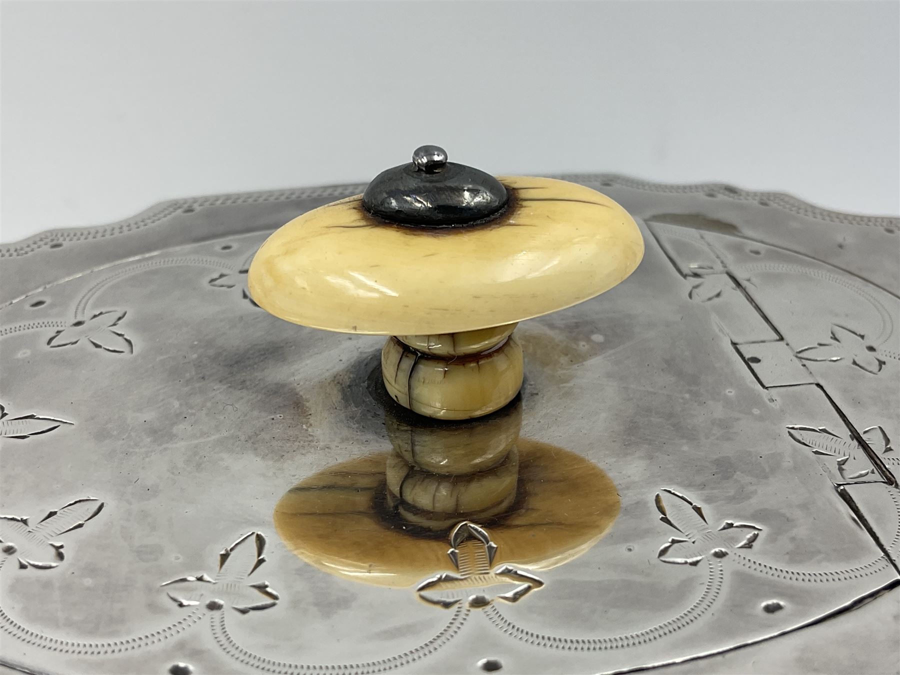 Victorian three-piece silver tea service, comprising teapot, twin handled open sucrier and milk jug, of oval form with shaped rim and C handles, each engraved with crests and bands of strapwork decoration, the milk jug and sucrier with gilt interiors, hallmarked Josiah Williams & Co, Exeter 1881, the teapot with ivory insulators and finial, all contained with a tooled leather, blue silk and velvet lined fitted case, retailed by West & Sun, Dublin 
This item has been registered for sale under Section 10 of the APHA Ivory Act