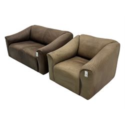 Mid-20th century two seater sofa, upholstered in soft brown leather with visible patina, curved arms and low back, on concealed supports (W138cm, D86cm, H72cm); matching armchair (W84cm, D86cm, H72cm)