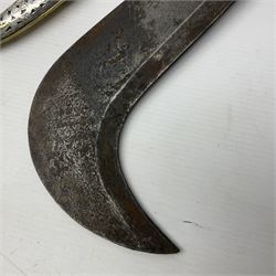Moroccan jambiya dagger with 24.5cm plain curved blade stamped LONDON to the ricasso area, the hilt and scabbard overlaid with plain sheet brass to the back and ornate silver coloured metal to the front; waisted grip and arched pommel; two pyramid mounts to the scabbard L41cm overall; large billhook with curving blade and stacked leather washer grip; and a reproduction halberd blade (3)