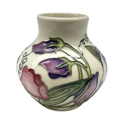 Moorcroft vase of squat form decorated in the Sweetness pattern by Nicola Slaney, with stamped marks beneath, H8cm