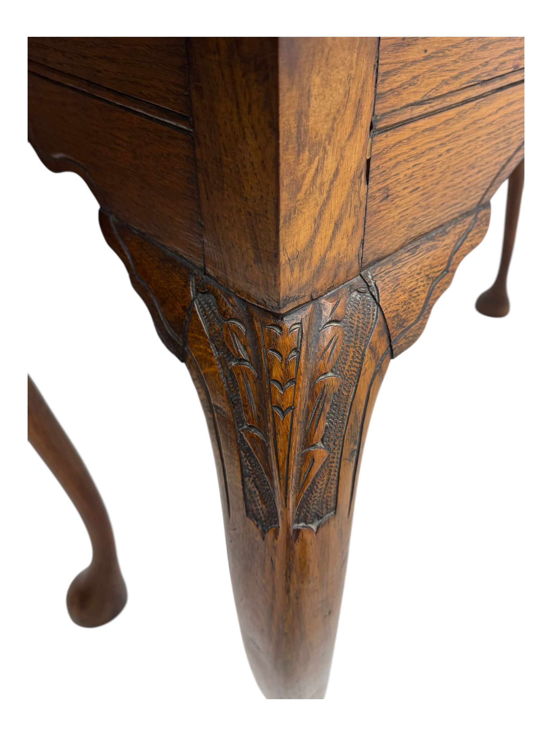 Late 19th century oak display cabinet, rectangular form with a pair of glazed doors enclosing shelves, raised on cabriole supports with carved detailing ending in claw feet