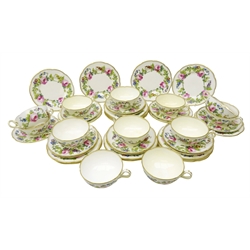  Early 20th century Minton part tea set, hand painted by J. Colclough with roses amongst foliage on plain ground within a gilded border, comprising twelve cups & saucers and seventeen plates, no. H2626 retailed by T. Goode & Co.  Provenance: West Heslerton Hall  