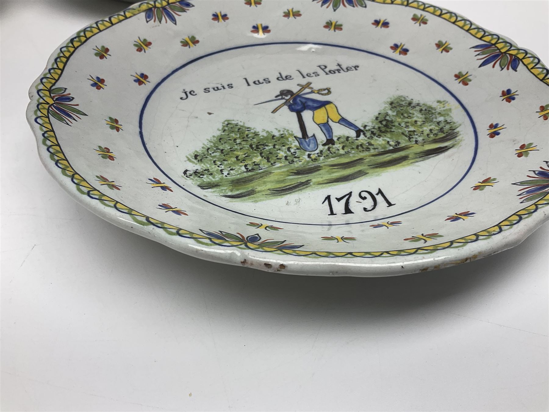 Four French Faience plates, comprising Je suis las de le porter, Le malheur nous reunit, Je desire y arriver and Eveque de Meaux, D24cm  