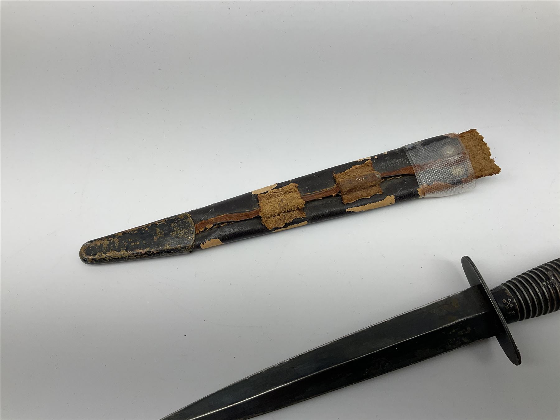 Post WW2 Fairbairn Sykes style black commando knife, no makers name but the handle marked with 'crossed keys *A' L30cm, in part scabbard