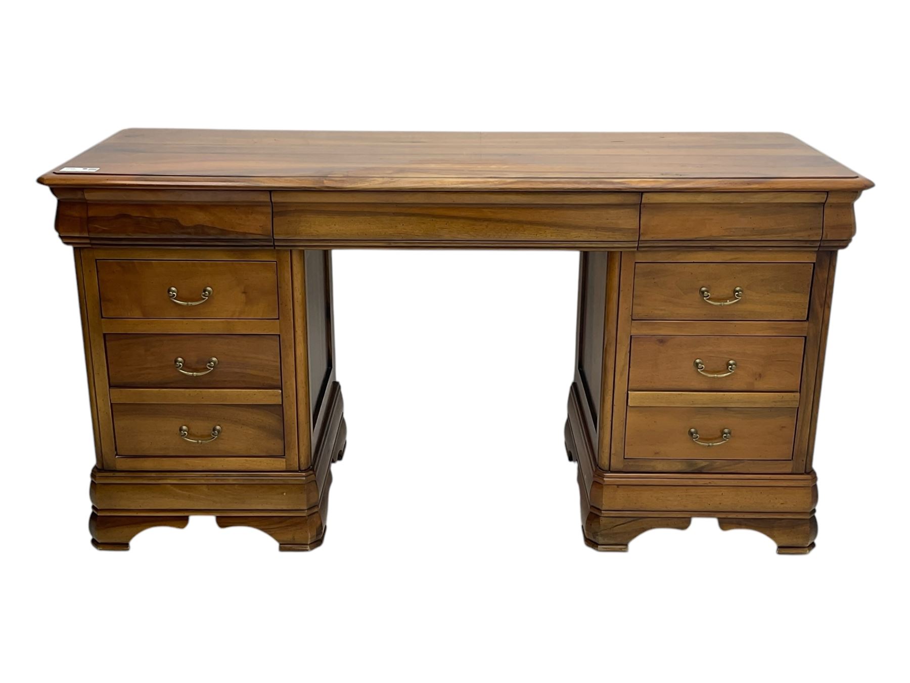 French cherry wood kneehole desk or dressing table, moulded rectangular top over twin pedestal bases each housing three drawers with brass-effect swing handles, resting on bracket feet