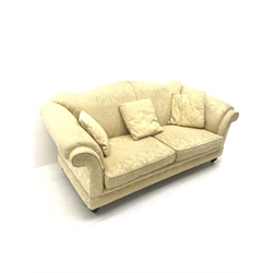 Licoln House three seat sofa, upholstered in a pale gold chenille fabric with floral pattern, shaped back, scrolled arms on turned supports, W200cm