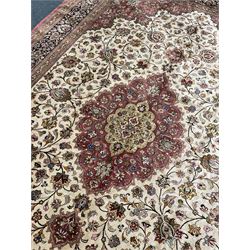 Finely knotted Persian Qom silk rug, overall pink ground with ivory field, the field with central cusped medallion profusely decorated with interlacing foliate and stylised flower heads, multiple band boarder, the main band decorated with a series of stylised motifs and trailing foliage, the outer guard with signature panel 