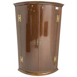 Georgian design mahogany hanging cylinder corner cupboard, fitted with two cupboard doors enclosing two shelves, with gilt metal mounts