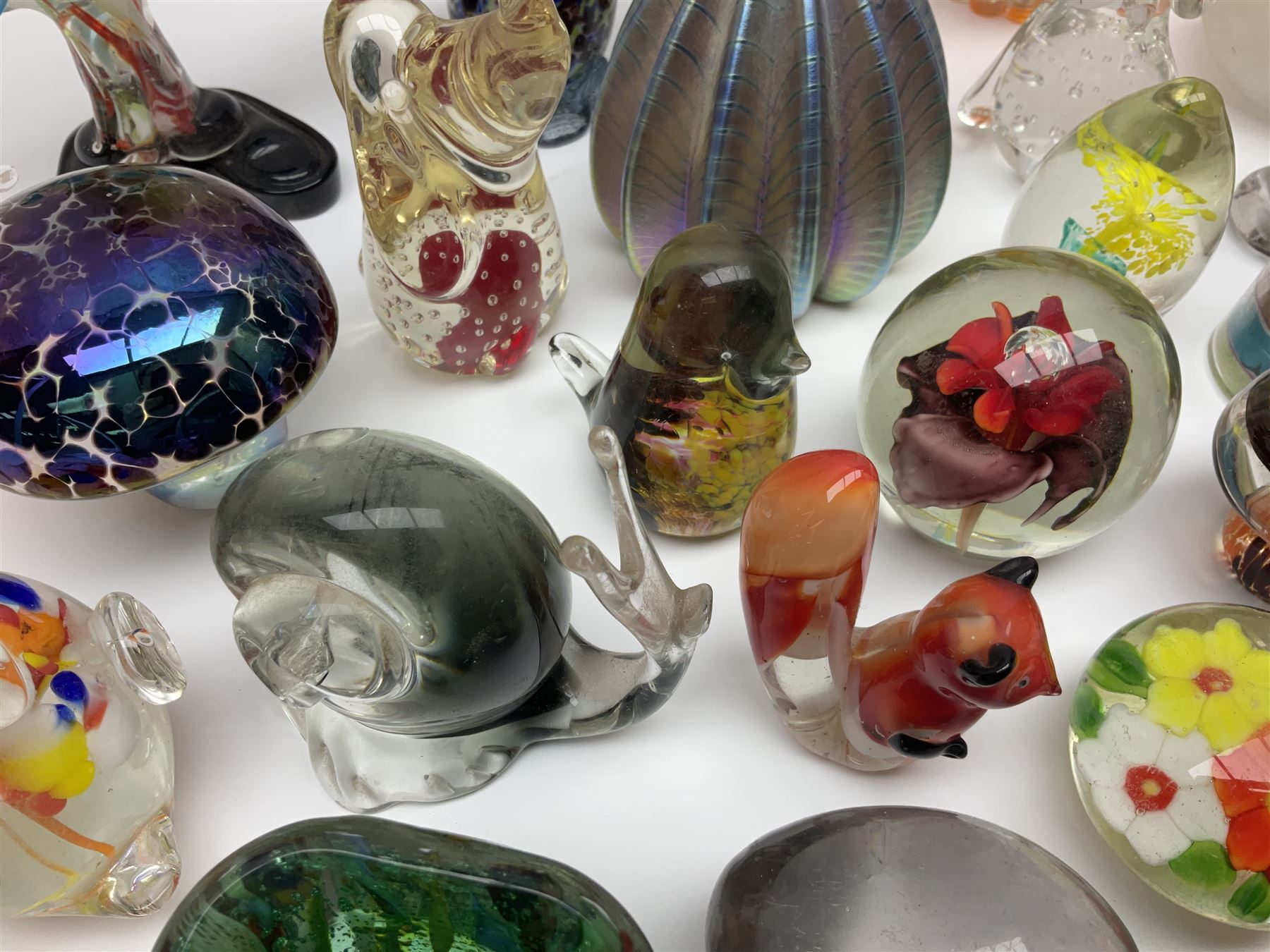 Robert Held iridescent art glass sea urchin paperweight, signed to underside, together with Murano glass clown and a collection of other glass paperweights and animals, etc 