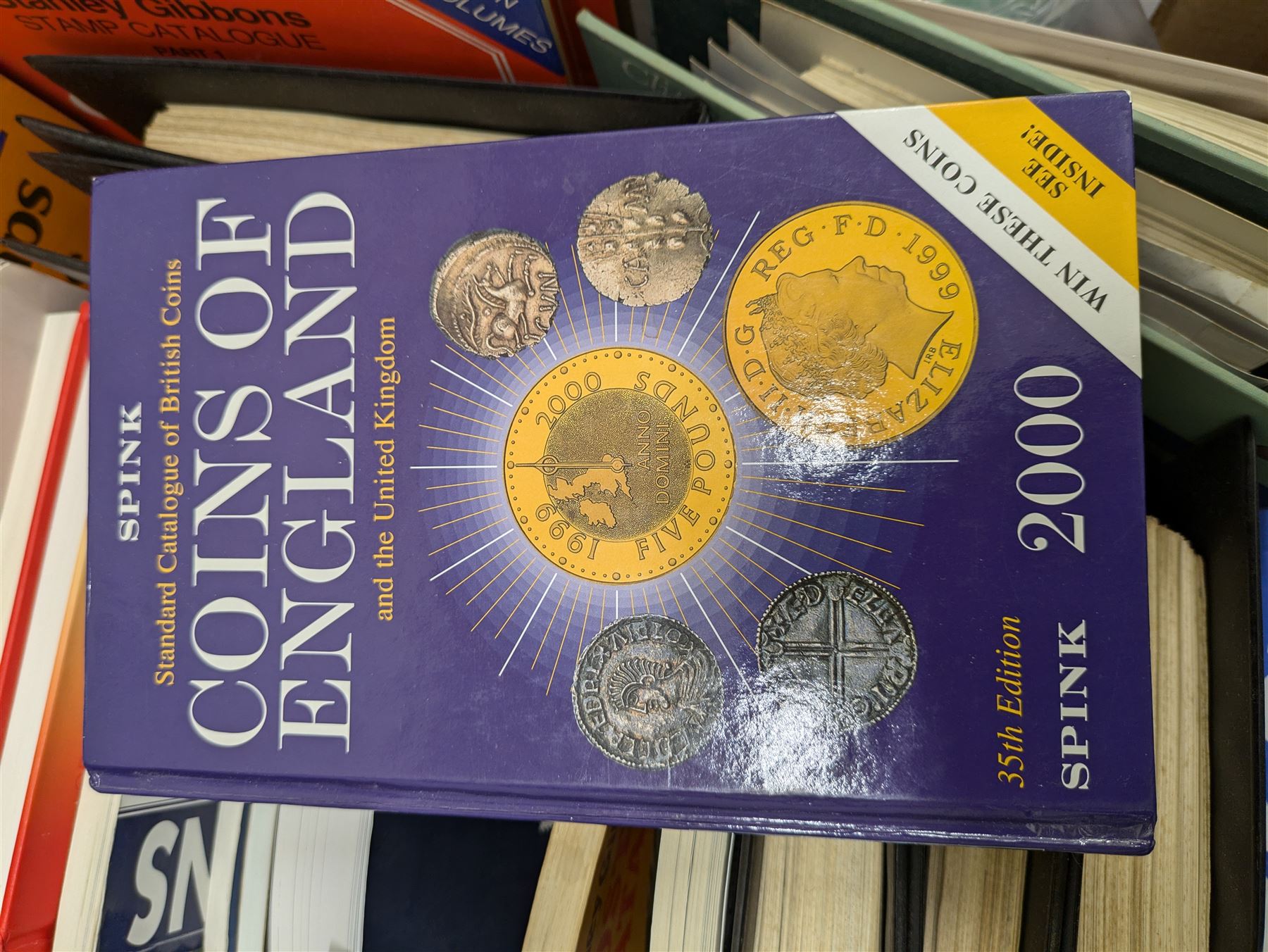 Stamp and coin reference materials, including Stanley Gibbons 2023 'Great Britain Concise' stamp catalogue, various editions of 'The Postal Stationary Society', empty stamp albums etc, in two boxes