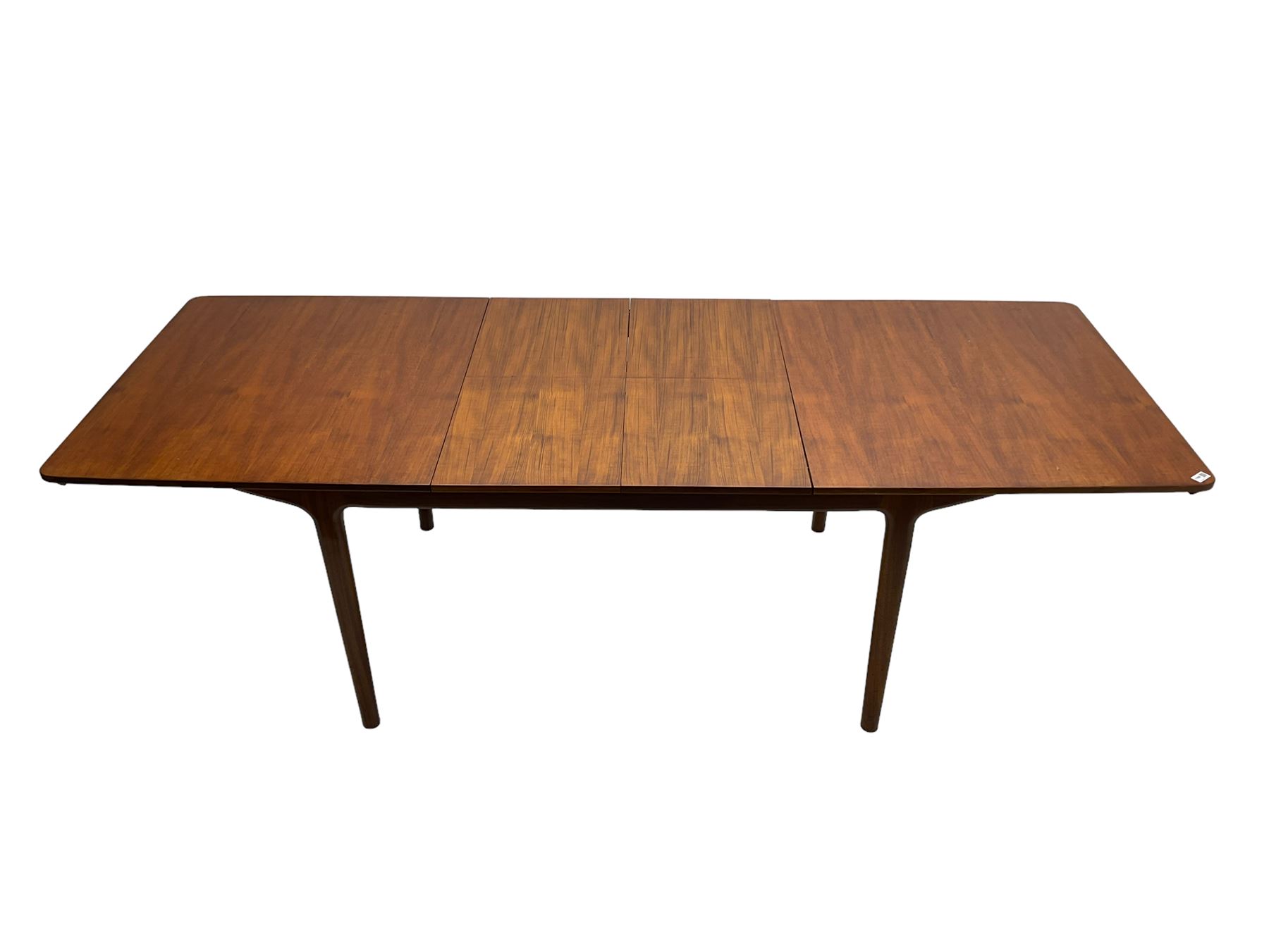 Tom Robertson for AH McIntosh & Co of Kirkaldy - mid-20th century teak extending dining table, rectangular top with rounded corners, concealed integrated double leaf, raised on tapered supports, metal label to underside of leaf