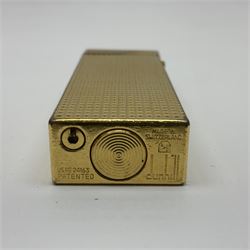 Dunhill gold plated lighter with engine turned decoration, in fitted case