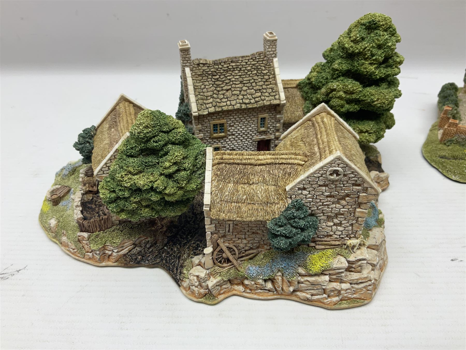 Three Lilliput lanes, comprising Oakwood Smithy, Anne of Cleves and Bluebell Farm, all with deeds and original boxes 