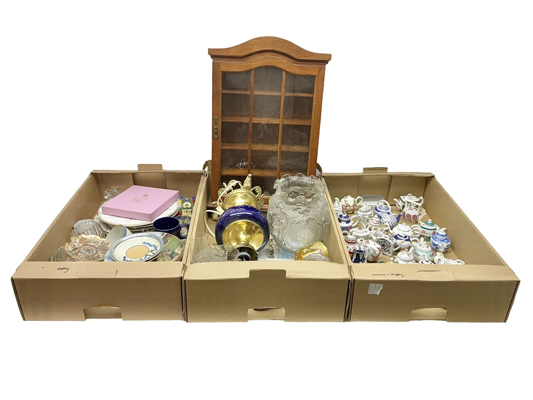 Twenty seven Porcelain Art miniature teapots, with wooden display together with a collection of other ceramics and glassware etc, including Goebel Hummel collectors plates, in three boxes,