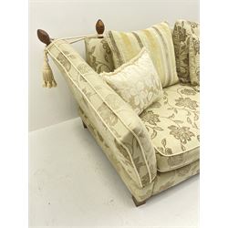 Grande Knole drop arm three seat sofa upholstered in pale fabric with raised floral pattern, with feather scatter cushions