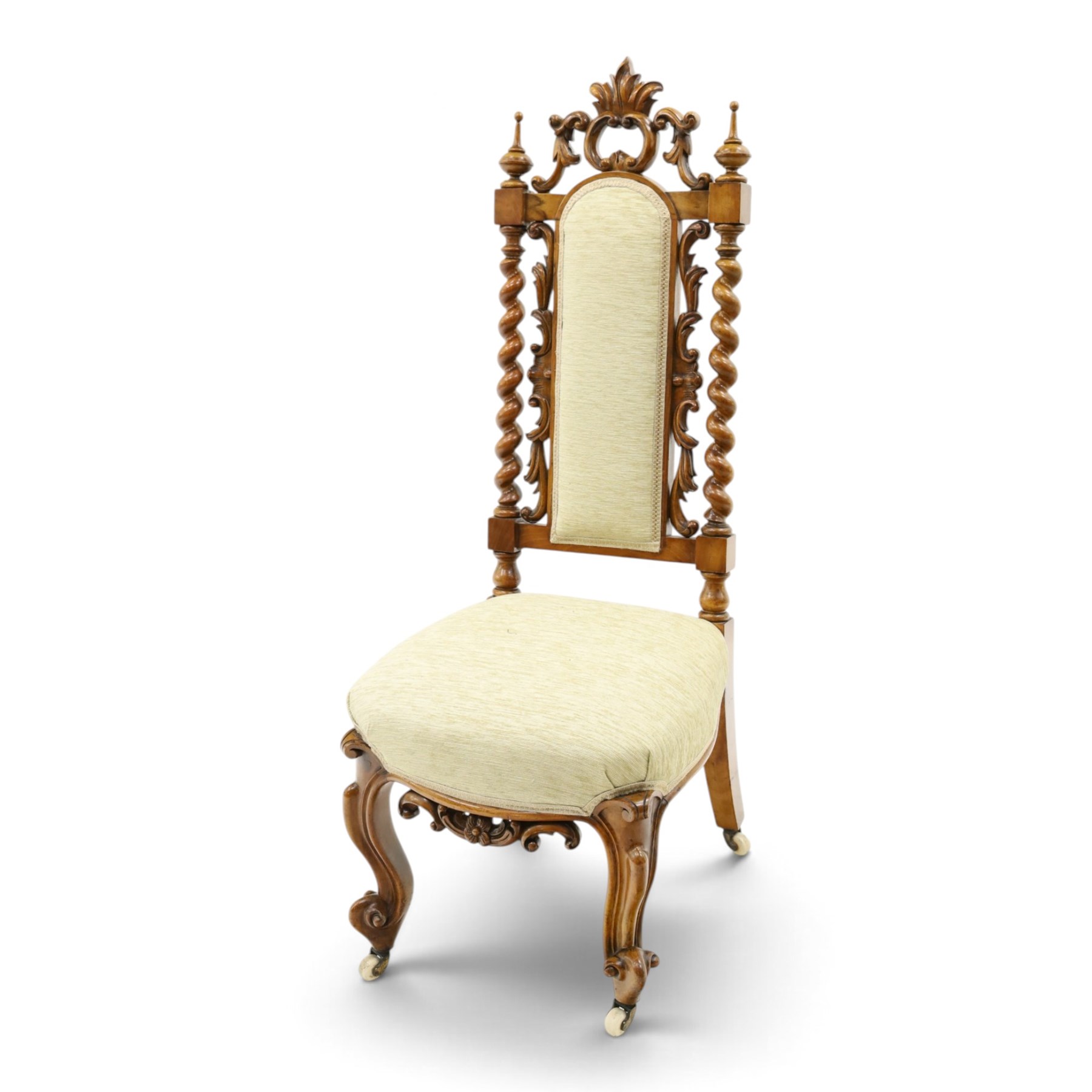Victorian carved walnut side chair, the ornate high back with pierced and carved scrolled cartouche cresting rail, the back panel and sprung seat upholstered in sage green fabric, flanked by scrolling acanthus leaves and spiral turned pilasters, raised on scroll carved cabriole legs with ceramic castors