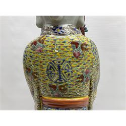 Chinese Republic Period porcelain figure, modelled as Shoulao, wearing elaborately enamelled robes decorated with peaches and flower heads, with impressed mark beneath, H55cm