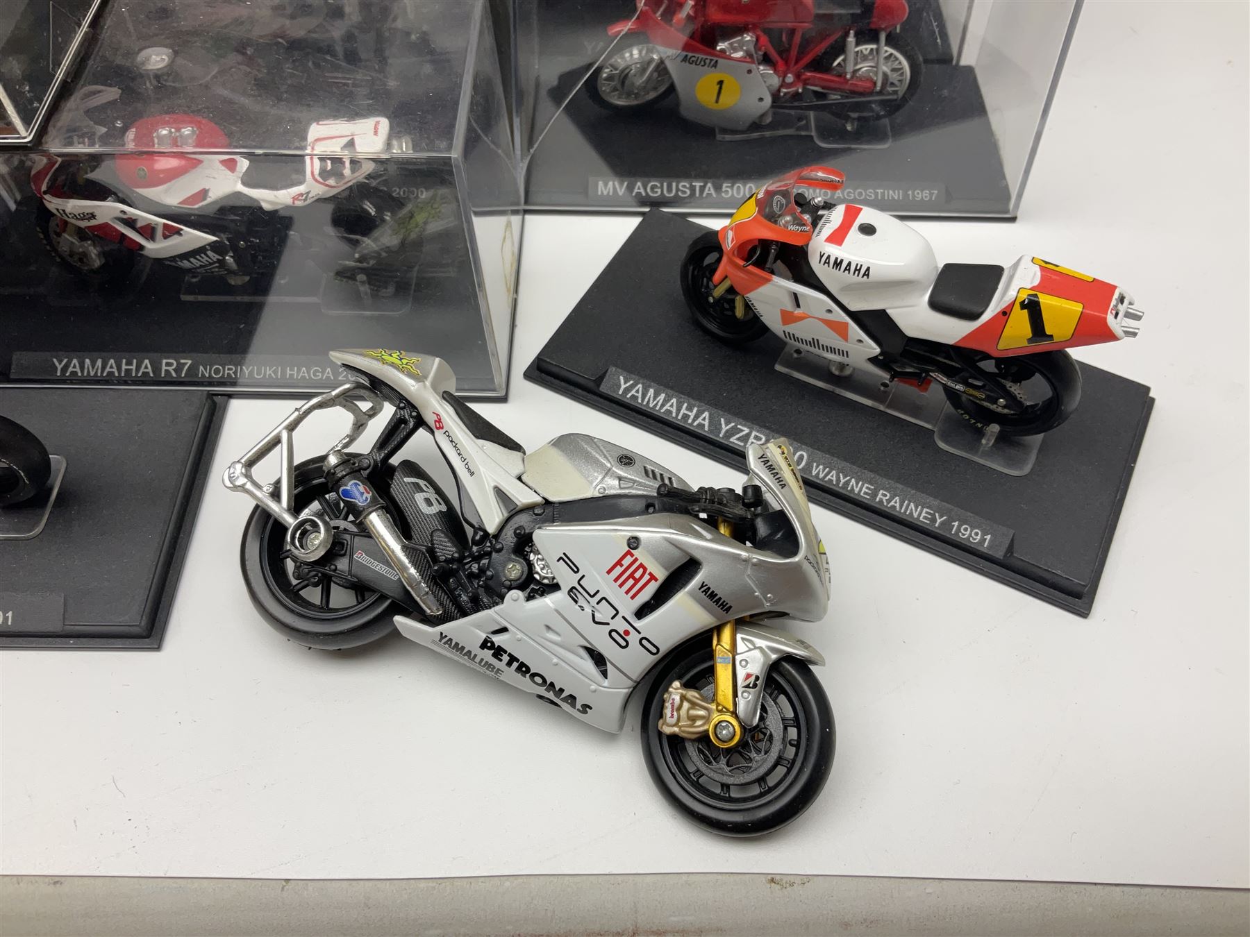 Fifty-one die-cast models of motorcycles by Maisto, Protar Italeri, Welly etc; many in perspex display boxes, some in window boxes and some unboxed