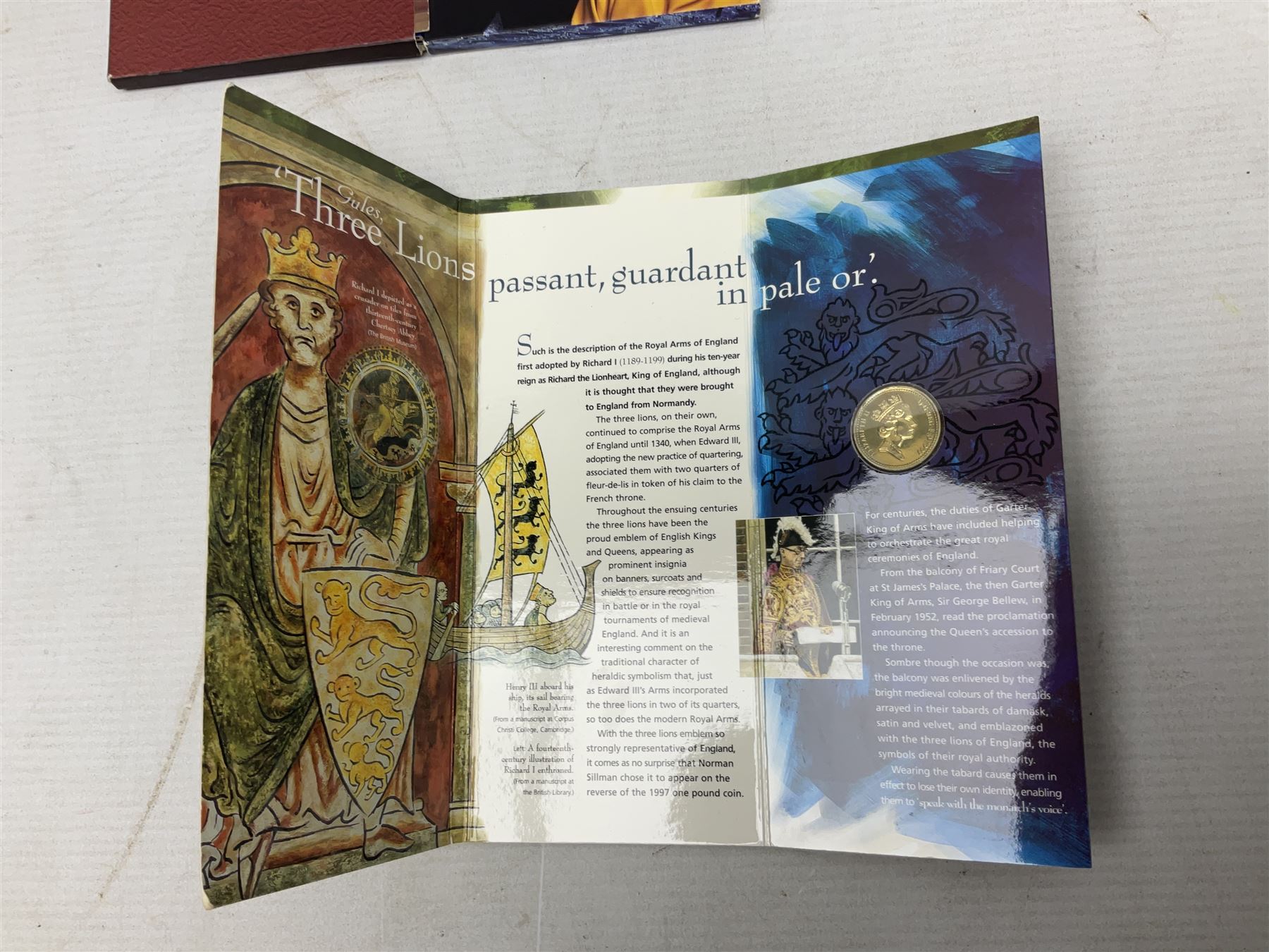 The Royal Mint United Kingdom 1984 brilliant uncirculated coin collection, 1997 and 2001 commemorative crown coins, 1997 old round one pound, all in card folders and four sterling silver medallic first day covers from the 'Great Britons' collection housed in a blue folder