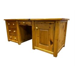 Large pine desk, rectangular top over four drawers, slide and panelled cupboard