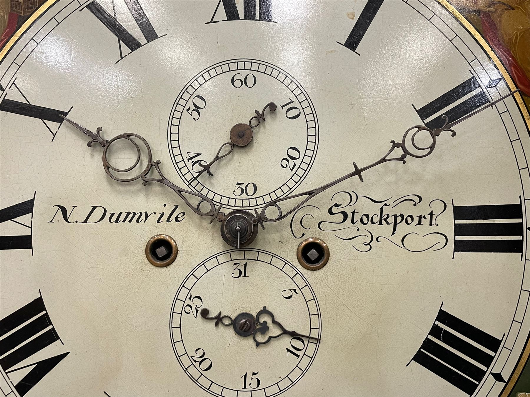 Nathaniel Dumville of Stockport - 8-day brass inlaid mahogany longcase clock c1840, swans neck pediment with ball and spire finials and wooden paterae, recessed break arch hood door flanked by rope twist pilasters, trunk with conforming pilasters and gothic ogee topped door, canted plinth raised on bracket feet, fully painted break arch dial with moon work and spandrels depicting the four seasons, centre with Roman numerals, minute track, subsidiary date and seconds dials, matching stamped brass hands, four pillar movement with an anchor escapement, rack striking on a bell. With weights and pendulum.
The Dumville family were prevalent Cheshire clockmakers working in Stockport 1820-42.
