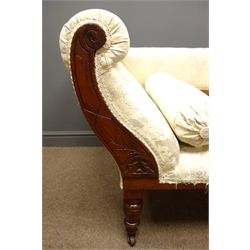  Edwardian walnut framed chaise longue, carved with scrolled flowers and foliage, upholstered in an ivory damask fabric, turned supports on castors, L180cm  