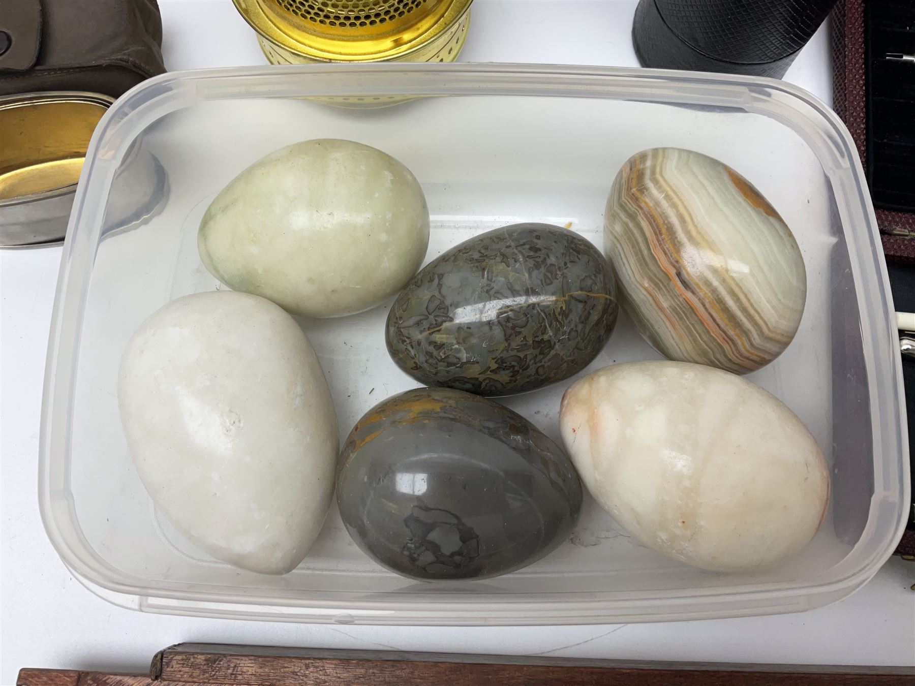 Pair of turned wooden goblets, six hardstone eggs, vintage slide rule and a leather letter rack, etc