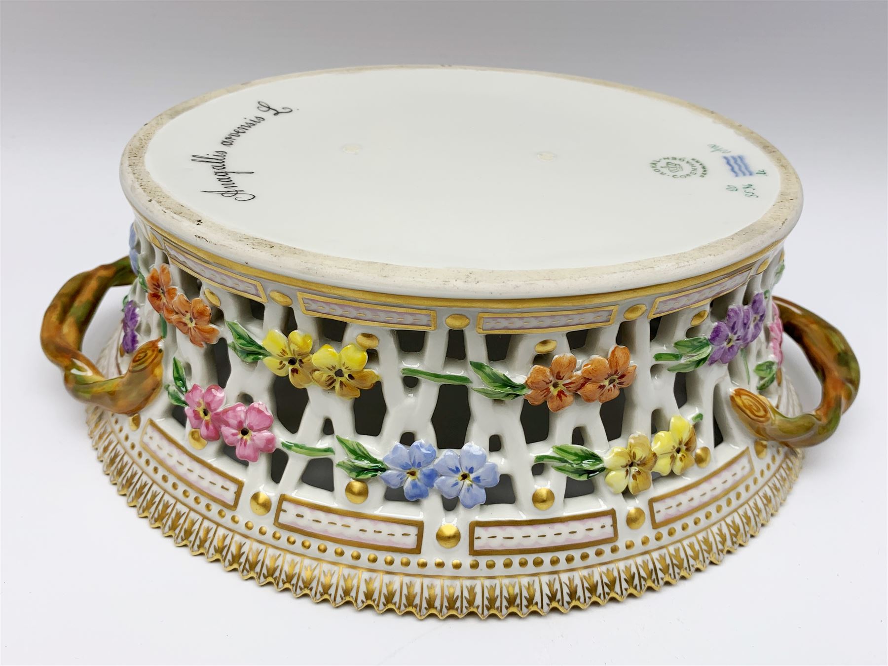 Royal Copenhagen Flora Danica basket, with naturalistically modelled vine handles and reticulated sides detailed with polychrome forget-me-nots, the interior decorated with a botanical study of 'Anagallis arvensis', sprigs and a gilt border, with printed and painted marks beneath, H8cm L26cm 

