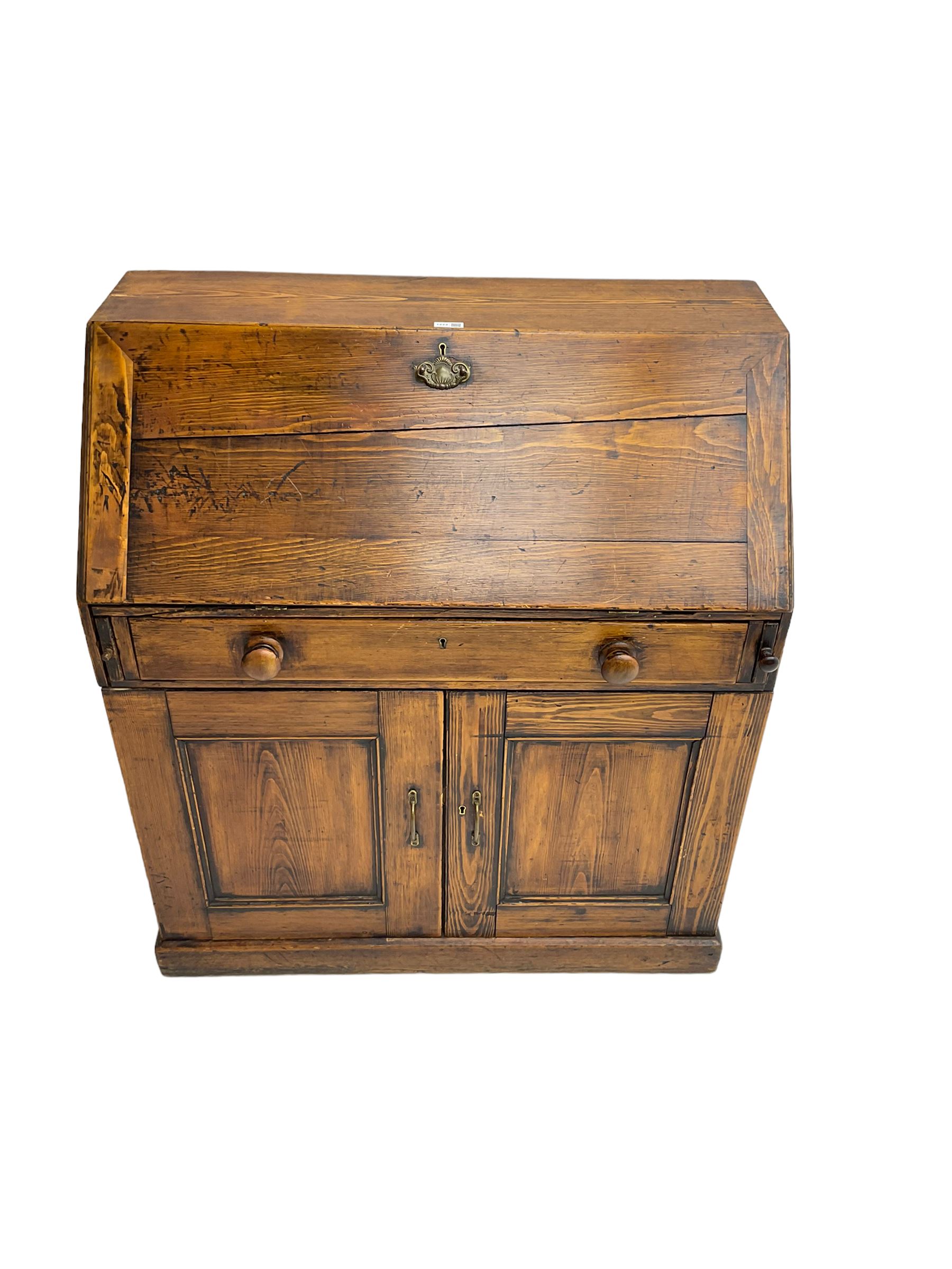 19th century waxed pine bureau, the fall front opening to reveal fitted interior with two drawers and five pigeonholes, base with single drawer over two panelled cupboard doors, on plinth base