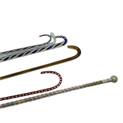 Six Victorian glass walking canes, to include three 'frigger' examples with colour twist designs, a 'hundreds and thousands' example with knop finial and filled with micro beads, possibly Nailsea, an opaque green twist example, and an amber glass example, longest L130cm