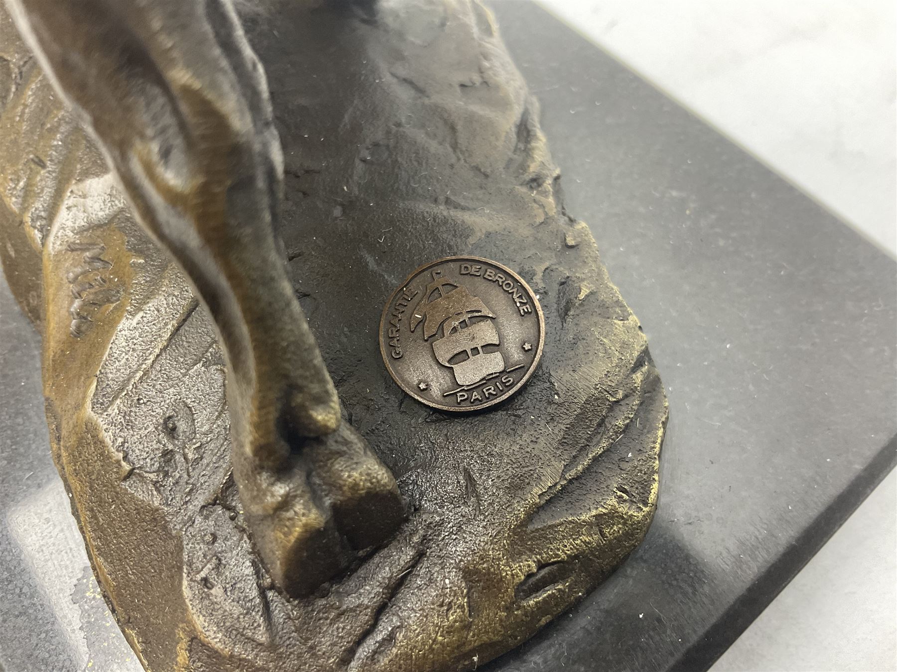 Bronze figure, modelled as a prancing bull, upon a naturalistic base signed Mils and with foundry mark, raised upon a rectangular marble base, overall H14cm