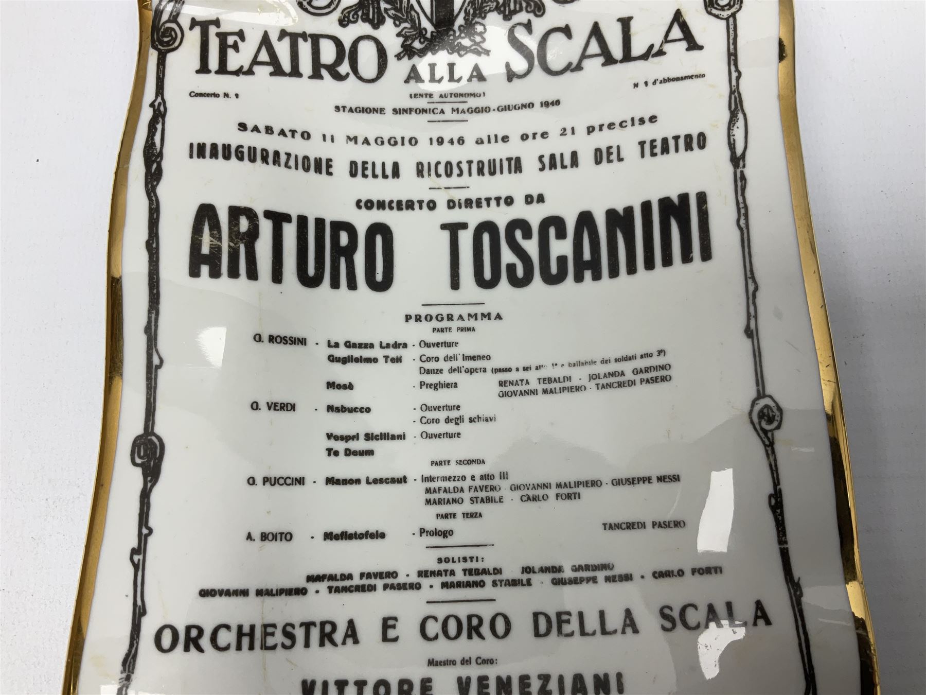 Fornasetti rectangular 'Toscanni's Concert' poster ashtray decorated with black and white text with a gilt border edge, with printed mark beneath, H22cm 