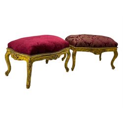Pair of Louis XV-design giltwood stools, each upholstered in red damask fabric with slight variations in patterns, the carved frames adorned with scrolling foliage and shell motifs, raised on cabriole supports