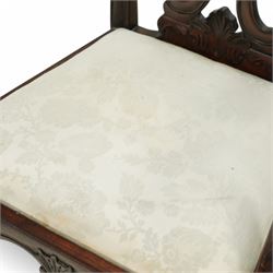 Chippendale revival mahogany dining chairs, set of six including a pair of carvers, the backs with intricately carved pierced splats beneath serpentine cresting rails, on acanthus carved cabriole front supports terminating in claw and ball feet, with cream upholstered drop-in seats