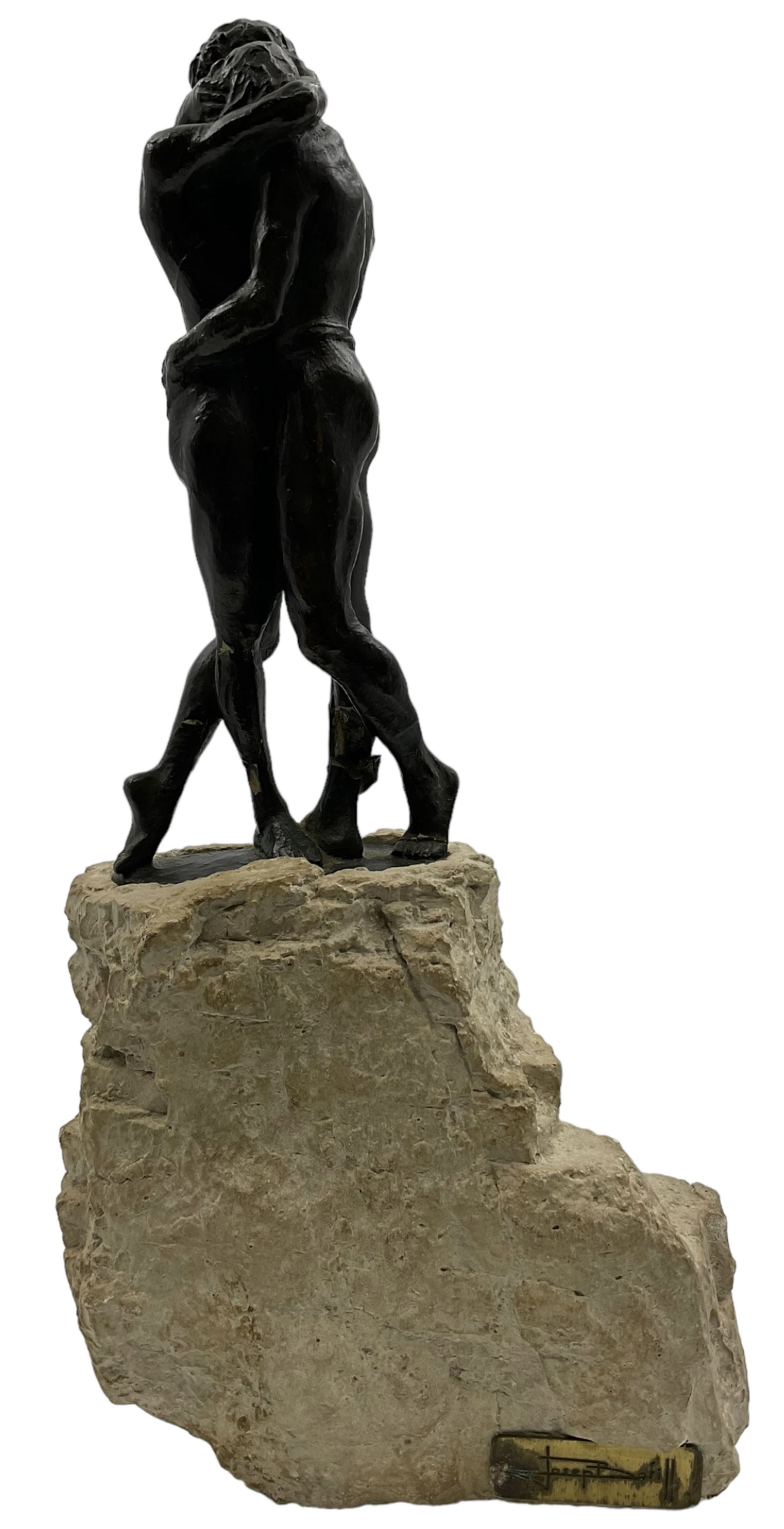 Composite sculpture embracing couple, after Joseph Bofill on a rocky base, height 33cm.