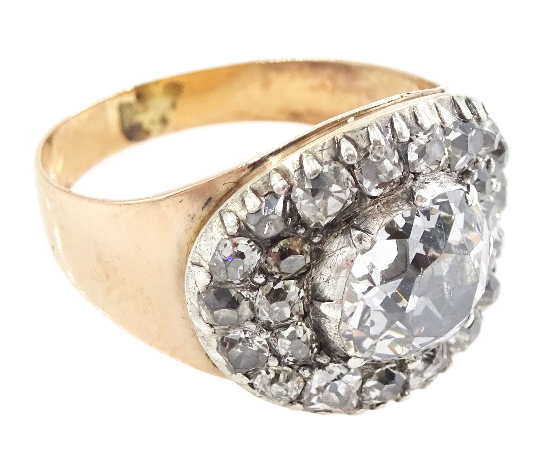 George III gold and silver old cut diamond cluster ring, the principal diamond of approx 0.75 carat, with pave set old cut diamond surround
