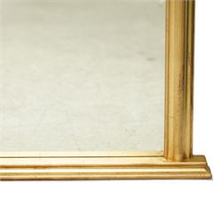 Contemporary large giltwood overmantel mirror, arched rectangular form with reeded moulded frame and stepped lower rail
