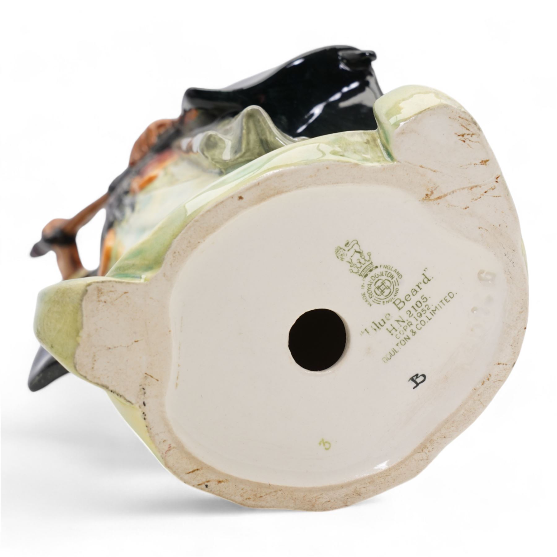 Three Royal Doulton figures comprising 'Sairey Gamp' HN1896, 'The Jester' HN2016 and  'Blue Beard' HN2105 (3)