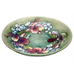 Moorcroft bowl decorated in Orchid pattern on a green ground, with impressed and painted mark beneath, D27cm