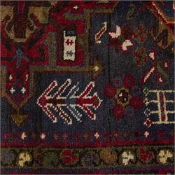 Large Northwestern Persian Hamadan hand-knotted runner, indigo field, with a column of bold geometric medallions and scattered stylized motifs within a madder border of angular rosettes and meandering vines 