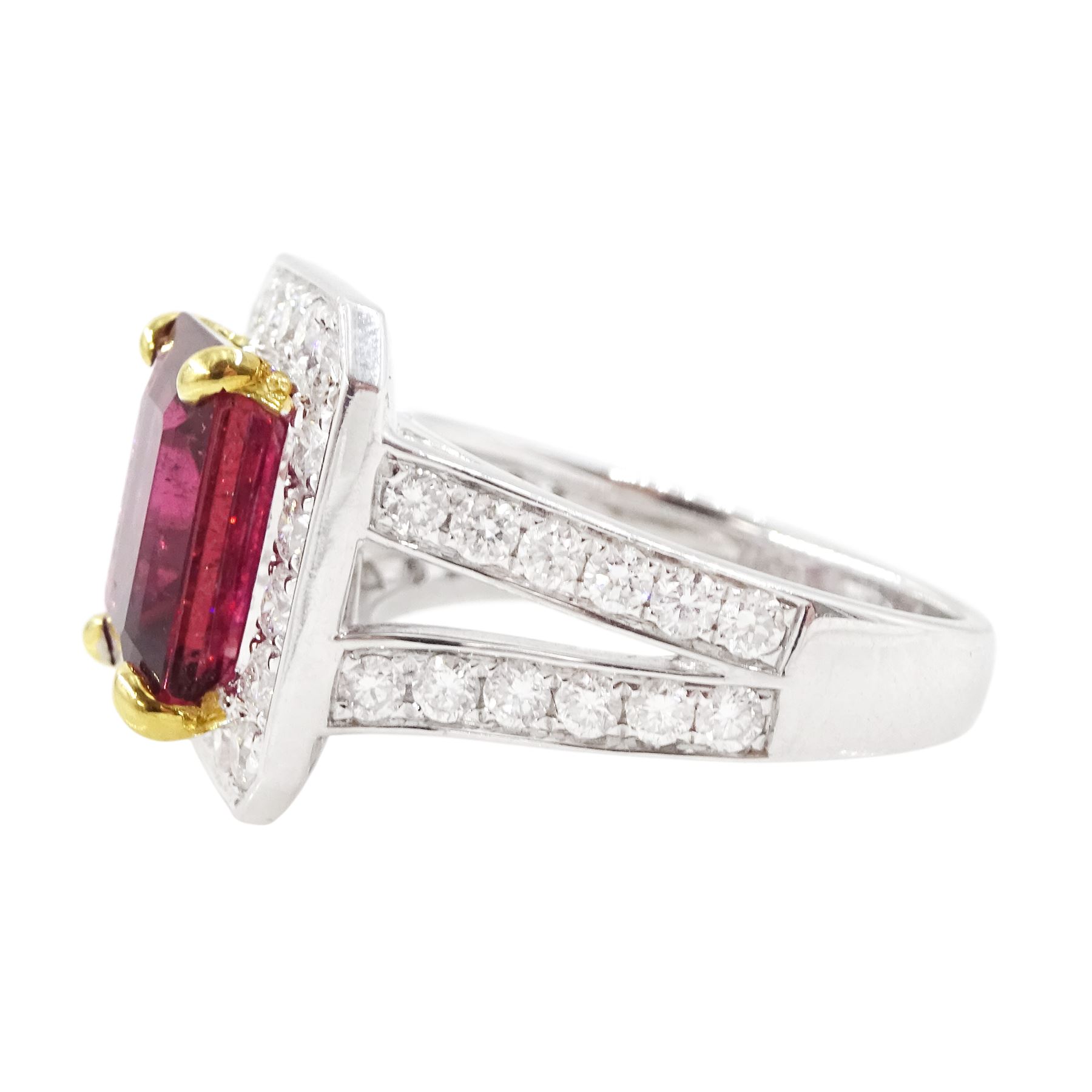 18ct white gold rubellite tourmaline and diamond cluster ring, single octagonal cut tourmaline of 4.05 carat, four claw set in yellow gold, surrounded by  round brilliant cut diamonds, with split diamond set shoulders, London 2013, total diamond weight 1.24 carat