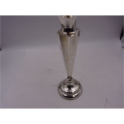 Early 20th century silver vase, of trumpet form, the fluted rim embossed with C scrolls and roses, with faceted stem, upon a circular stepped weighted foot, hallmarked Chester 1911, maker's mark worn and indistinct, H25.7cm