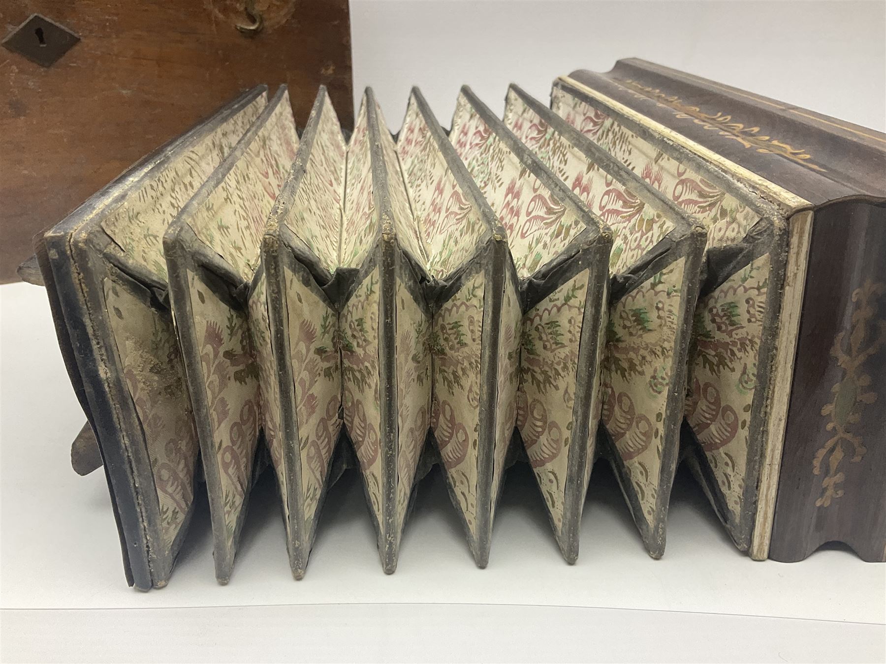 19th Century inlaid rosewood Flutina accordion, stamped Busson of Paris, having sixteen mother of pearl keys and six fold floral decorated bellows L30cm; in baize lined mahogany box