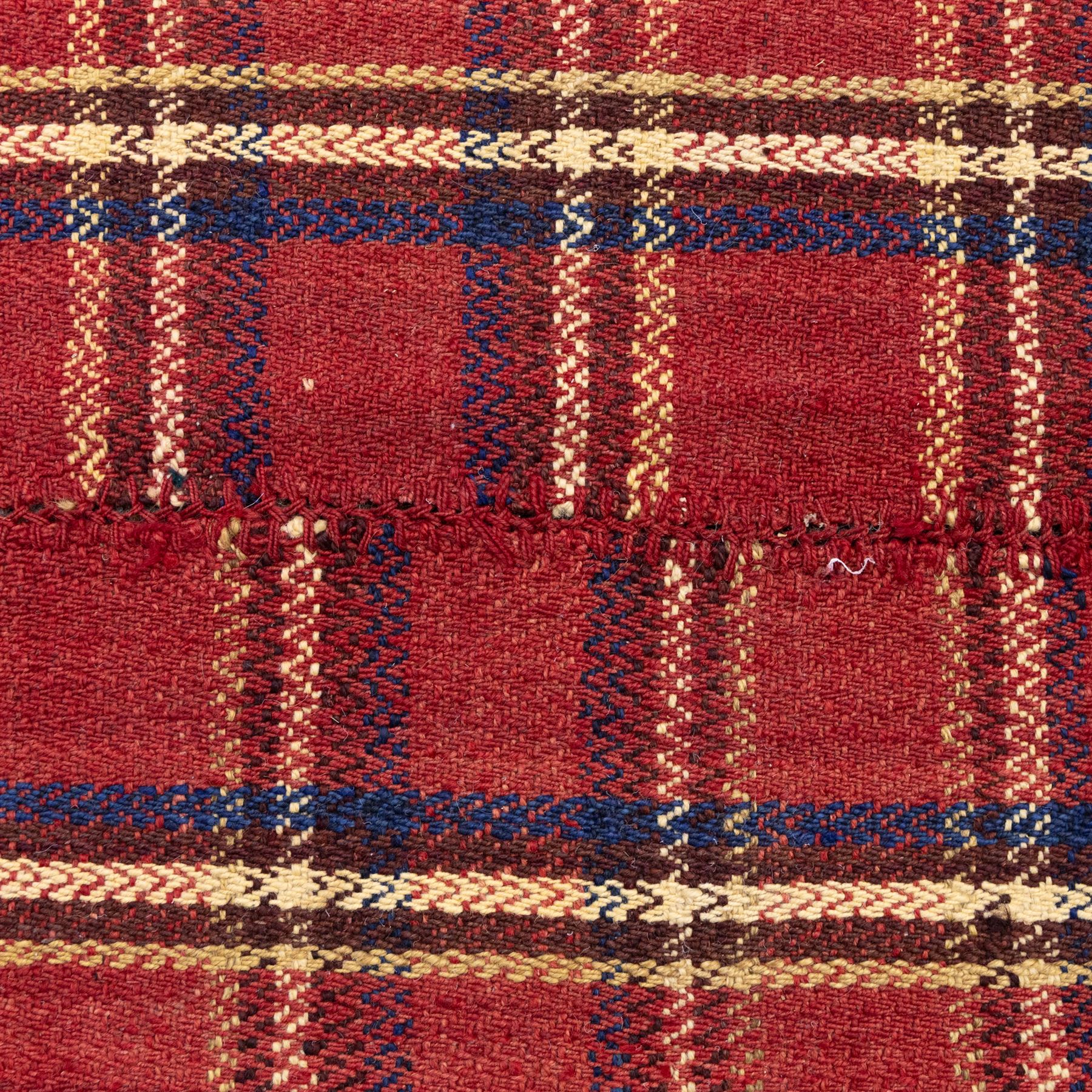 South West Persian Jajim kilim flatweave runner, composed of joined narrow woven bands,  field decorated with checked and striped motifs in shades of madder red, indigo, ivory ochre, and green, sides applied knotted wool tufts and braided elements with tasselled edges, (due to the large size, the runner is illustrated in two sections) 